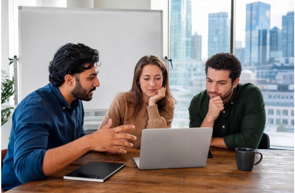 launch
Image Alt Text
A small team of colleagues discusses work around a laptop at a table in a bright modern office with a city skyline outside.
A small team of colleagues discusses work around a laptop at a table in a bright moder